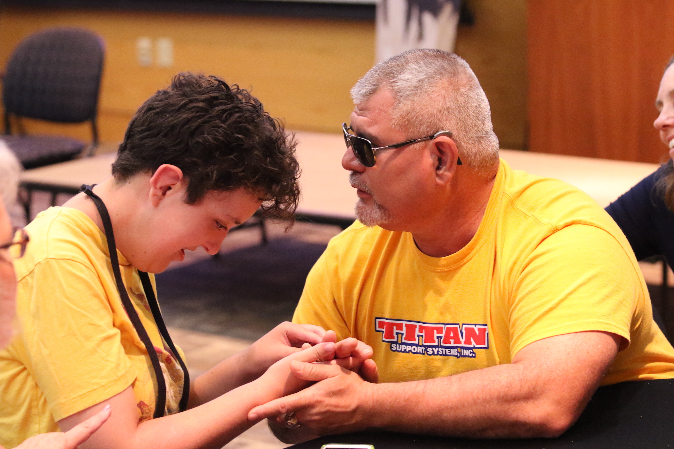 A young woman signing with a mentor.