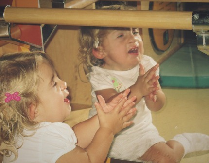 Young Laci looking at herself in the mirror.