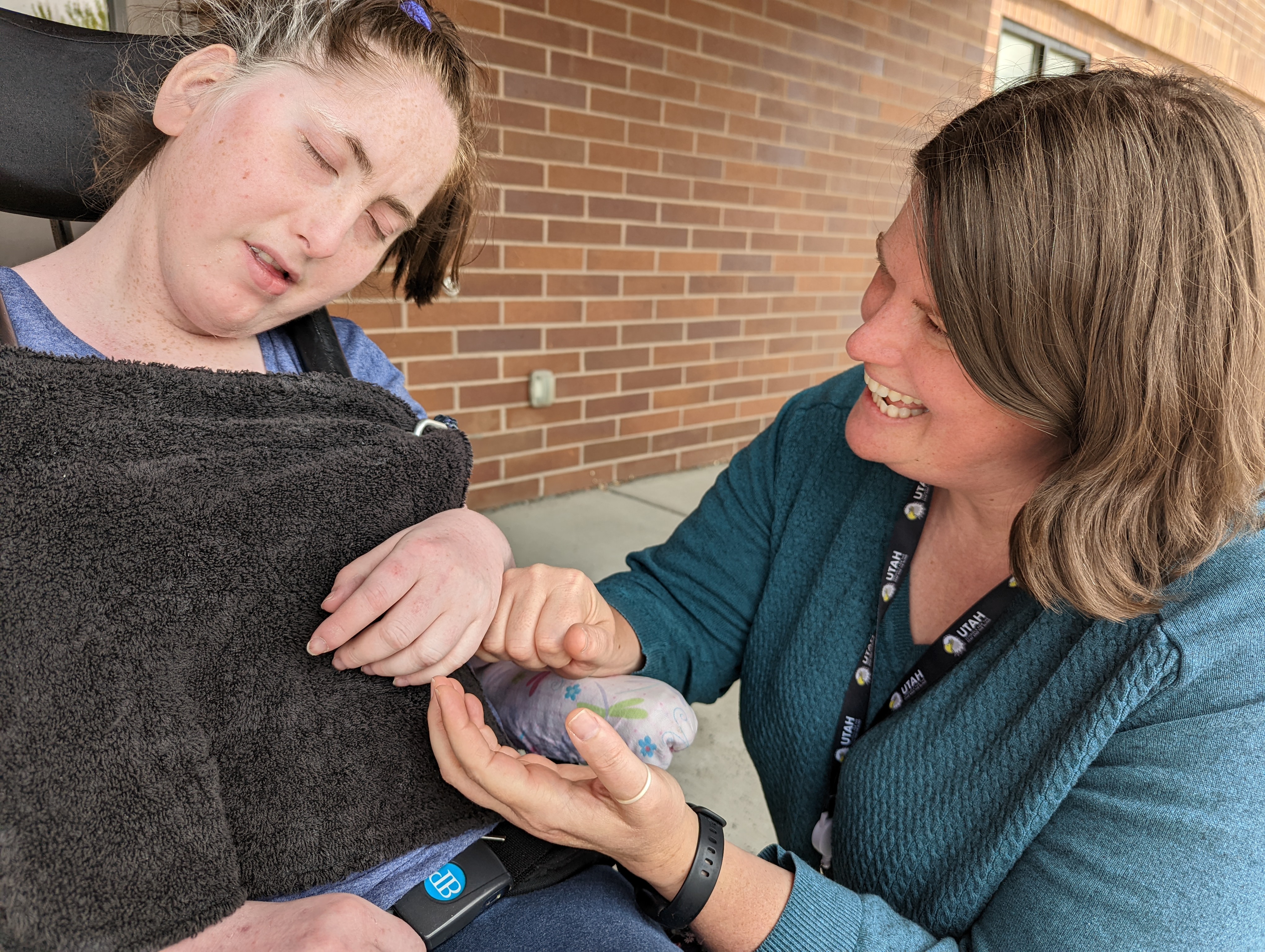 Brooke reaches out her hands to a student.