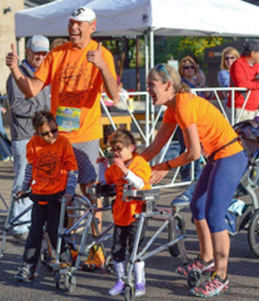 Soliz and Camila walking with their walkers in a 5k race.