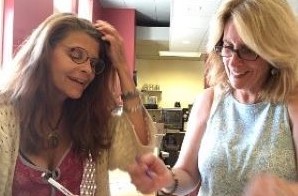 Two teachers sit side by side at a table working together.